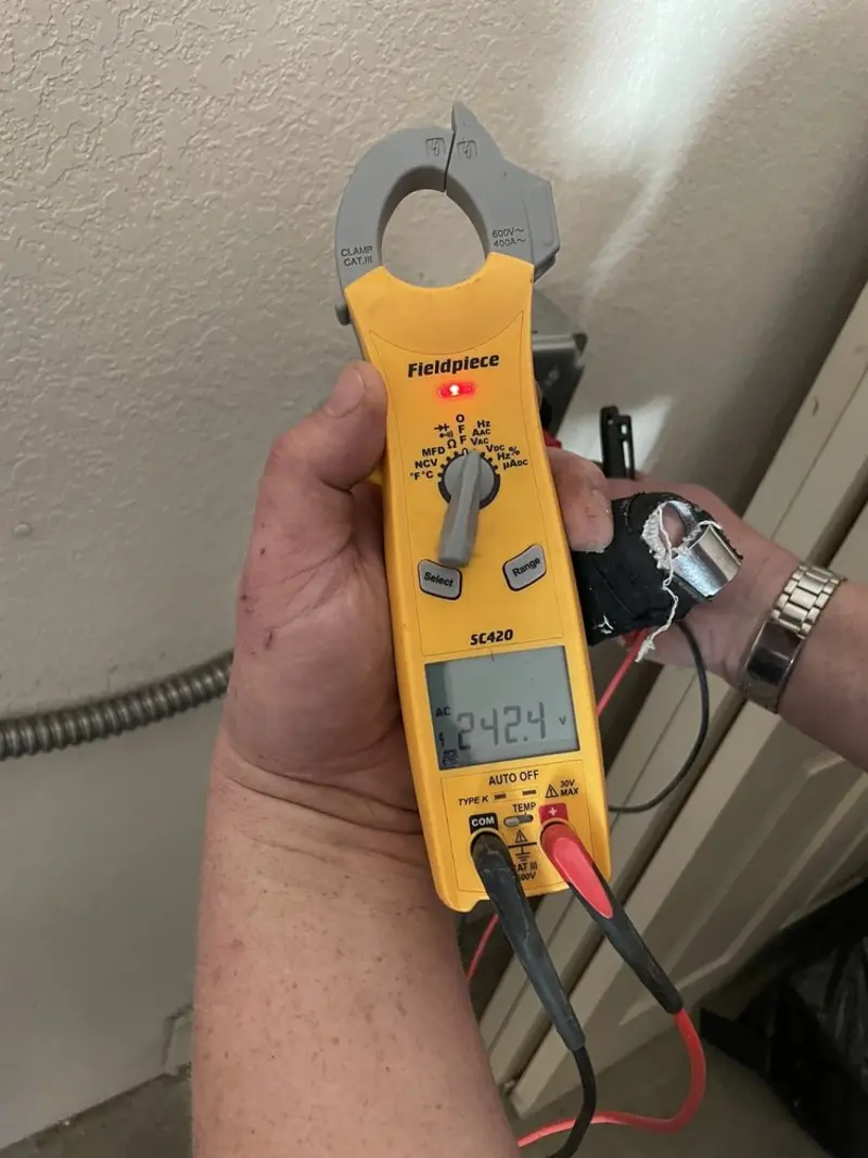 Voltage testing with clamp meter during Recessed Lighting Installation in Wilton